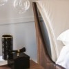 Cama Nelson de Cattelan Italia. Cama con estructura en madera de nogal o fresno.